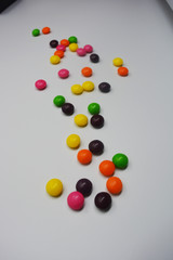 A lot of round sweets like tablets, medicine with bright color and taste. This color sweets are round beads, rainbow color stones. It's popular delicious colorful sweet with sweaty and lively form.