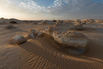 Fototapeta na wymiar sunrise landscape at the zone of el-khiyam, also named the tents, typical limestone formations in the Egyptian white desert national park