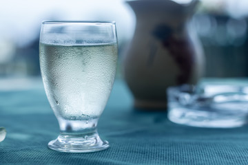 drops on misted on a glass of white wine on the table