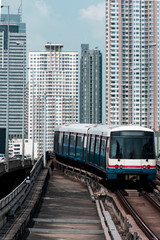 Fototapeta na wymiar Transportatation by train in Bangkok with train and city skyline at background.