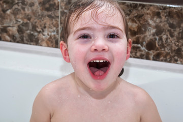 Baby girl smiling showing face in bathroom,
