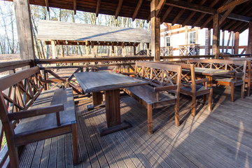 wooden tables and chairs in the outdoor gazebo