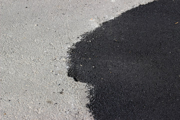 New and old asphalt surface patch city street