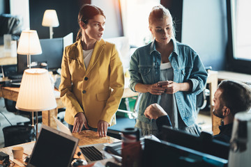 Two women employees and chief manager have meeting in the office