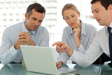 corporate business teamwork - businessmen and woman working on laptop