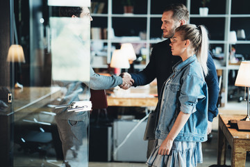 Successful meeting handshake. Three business people in the office discuss new work plan