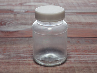 Transparent plastic bottle on a wood background. Concept No plastic