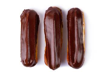 Traditional french dessert. Isolated eclairs with custard and chocolate icing on white background....