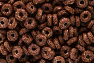 Texture and background of dry, chocolate rings for cereals breakfast.