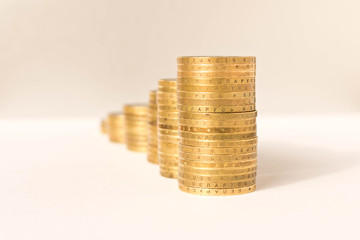 Stacks of coins on a light background. Business concept and growth of capital.