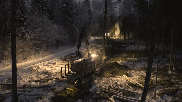 The log harvester getting logs at night time