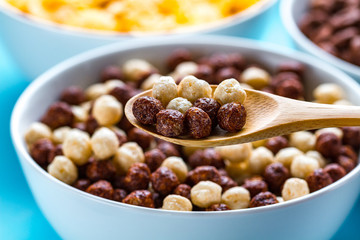 Dry, cereals breakfast. Spoon and bowl with chocolate white and brown balls