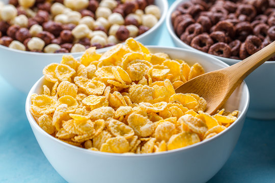 Dry, Cereals Breakfast. Spoon And Bowl With Frosted Yellow Corn Flakes