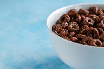 Chocolate glazed rings bowl for dry, cereals breakfast. Copy space