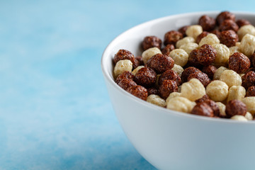 Chocolate glazed brown and white balls bowl for dry, cereals breakfast. Copy space