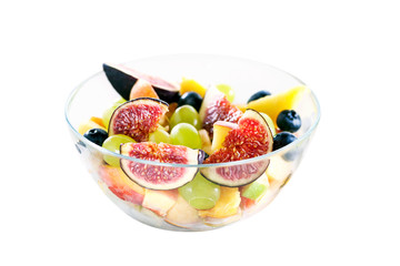 Fruit salad in a glass bowl isolated on white background