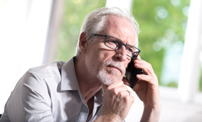 Senior businessman talking on mobile phone