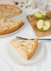 a piece of Apple Pie on a table, light background, close-up