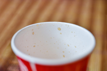 Red plastic cup with drops of carbonated drink
