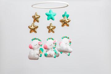 Colorful and eco-friendly children's mobile from felt. On gray background.
