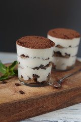 Italian dessert tiramisu closeup on wooden table,mint