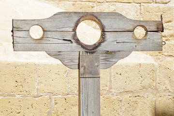 Old wooden medieval pillory close up