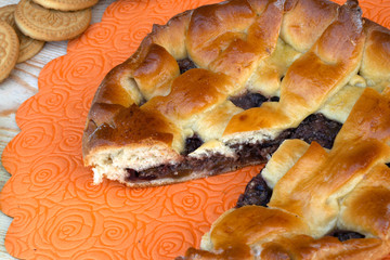 apple jam pie, cherries, walnuts and cookies on the table