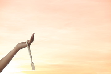 Empty hands holding a rosary for praying supplication, Concept: symbol prayer faith worship Islam in the month of Ramadan, forgiveness, spiritual-cultural trust