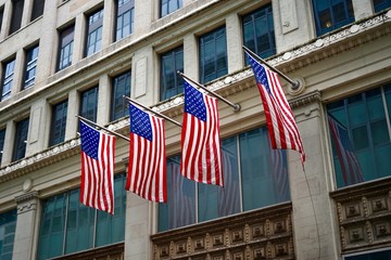 Four USA Flags Proudly Hanging from the Building Facade