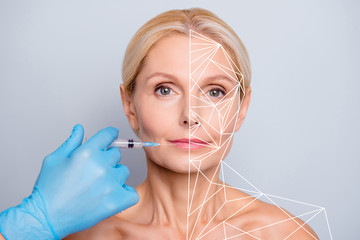 Portrait of nice charming attractive adorable aged woman with wrinkle making injection in lips in...