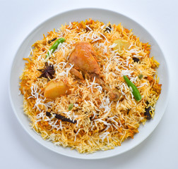 Chicken Biryani, A famous Indian Sub-continent savory rice dish mixed with spicy marinated chicken, spices and flavorful saffron.