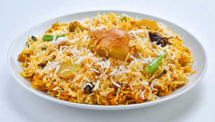 Chicken Biryani, A famous Indian Sub-continent savory rice dish mixed with spicy marinated chicken, spices and flavorful saffron.