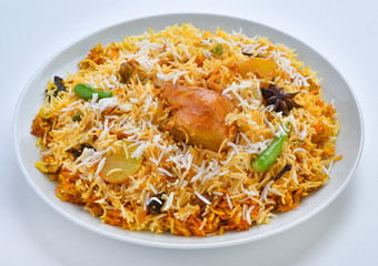 Chicken Biryani, A famous Indian Sub-continent savory rice dish mixed with spicy marinated chicken, spices and flavorful saffron.