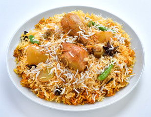 Chicken Biryani, A famous Indian Sub-continent savory rice dish mixed with spicy marinated chicken, spices and flavorful saffron.