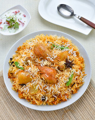 Chicken Biryani, A famous Indian Sub-continent savory rice dish mixed with spicy marinated chicken, spices and flavorful saffron.