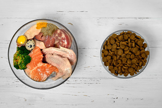 Natural raw dog food BARF diet as opposite of kibble dry food Concept Closeup