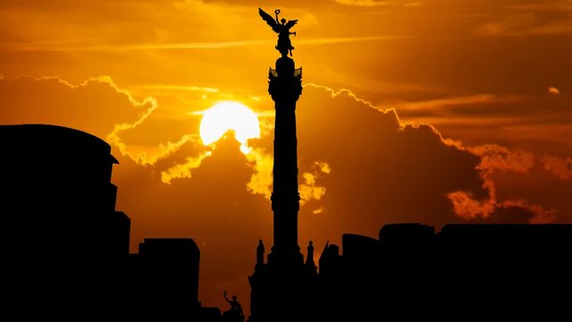 The Angel of Independence ( Monumento a la Independencia ) and Skyline of Mexico City at Sunset, is a Victory Column on Paseo de la Reforma in Downtown, Worlwide Known Symbol of the Capital