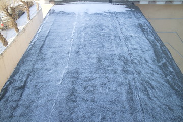 Roof covered with roofing felt in winter