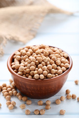 Chickpeas in bowl on wooden table