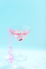 Cocktail in glass on blue background. Minimalism concept