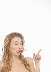 Beautiful, sexy, young woman points at the top right, funny facial expression, shows free space for your advertising content. The concept of emotions