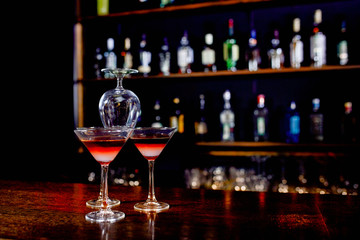 The pyramid of cocktails on the bar on a blurred background of the restaurant.