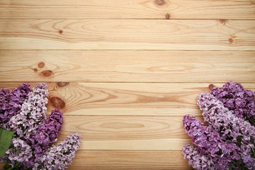 Purple lilac flowers on brown wooden table