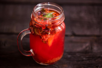 Close up glass jar with delicious healthy raspberry tea drink