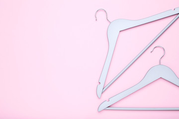 Grey hangers on pink background