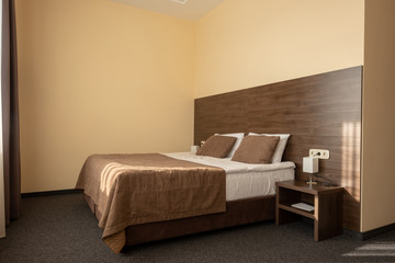 modern hotel bedroom interior with bed in brown color