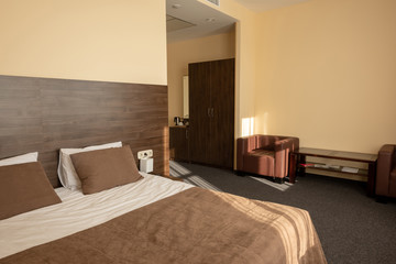 hotel bedroom interior with bed in beige color