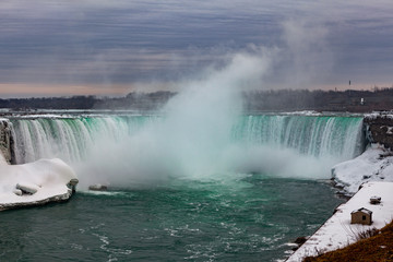 Niagara Falls CANADA - February 23, 2019: Winter frozen idyll at Horseshoe Falls, the Canadian side of Niagara Falls, view showing as well as the upper Niagara River