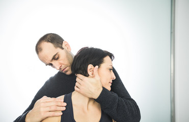 Fototapeta premium Close-up of a physiotherapist massaging the neck of a beautiful young woman. Concept of health treatments and physiotherapy