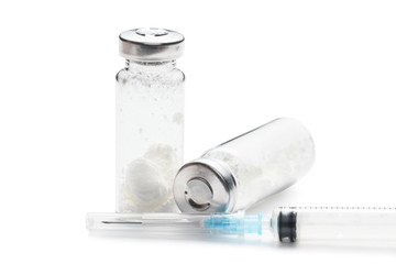 Injection bottles with white powder and syringe.